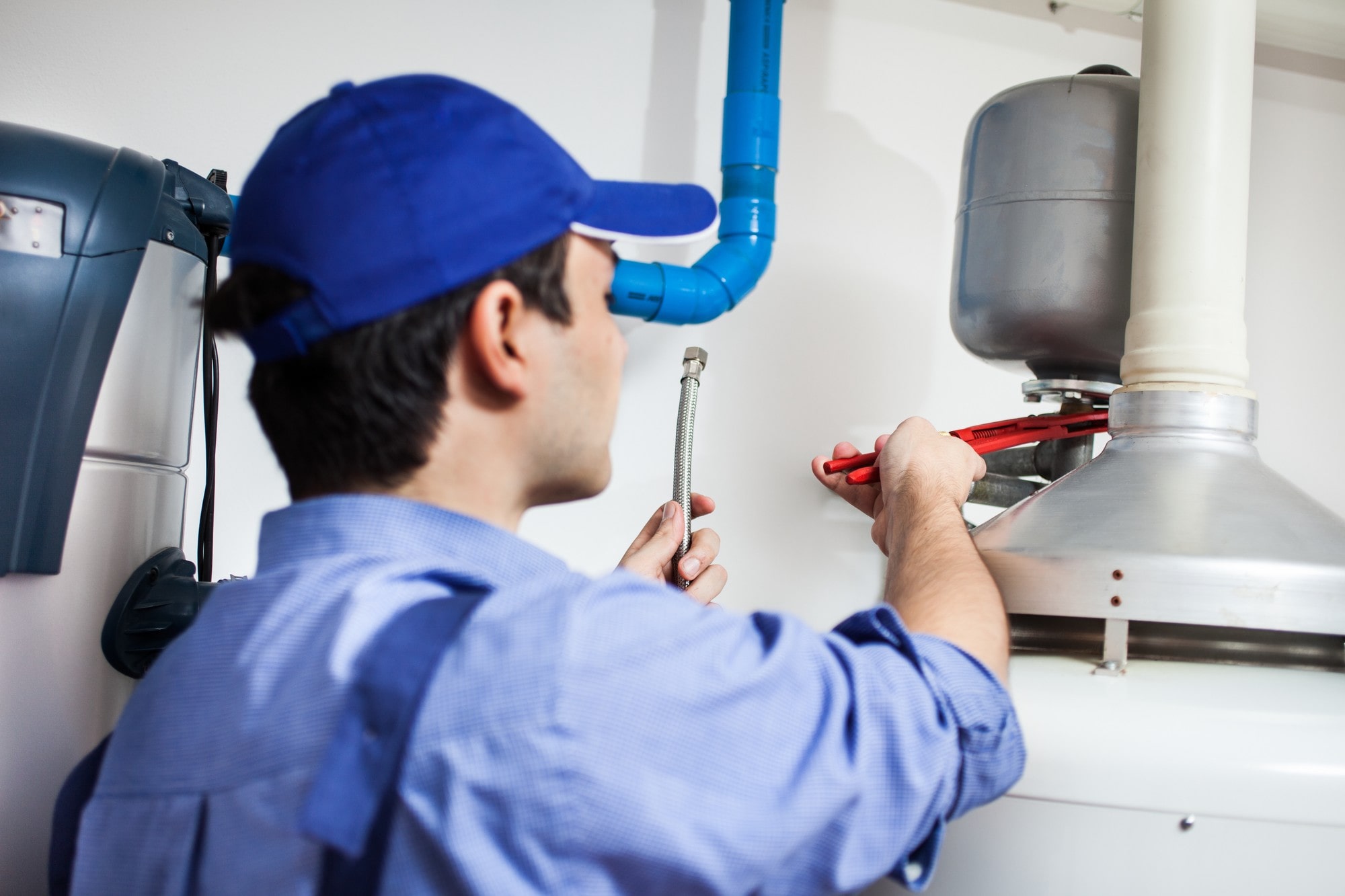 Plumber Working On The Hot-Water Heater